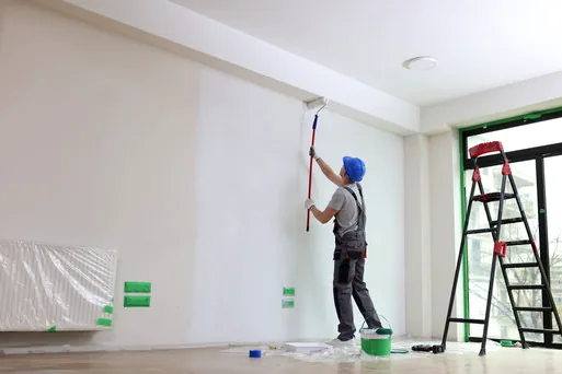 Painter rolling a bright fellowship hall wall in a Raleigh church