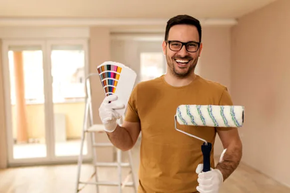 Raleigh historic painter holding a fan deck and roller
